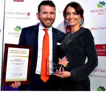Paul and Helen holding their award: regional winner for funeral planner of the year 2016.
